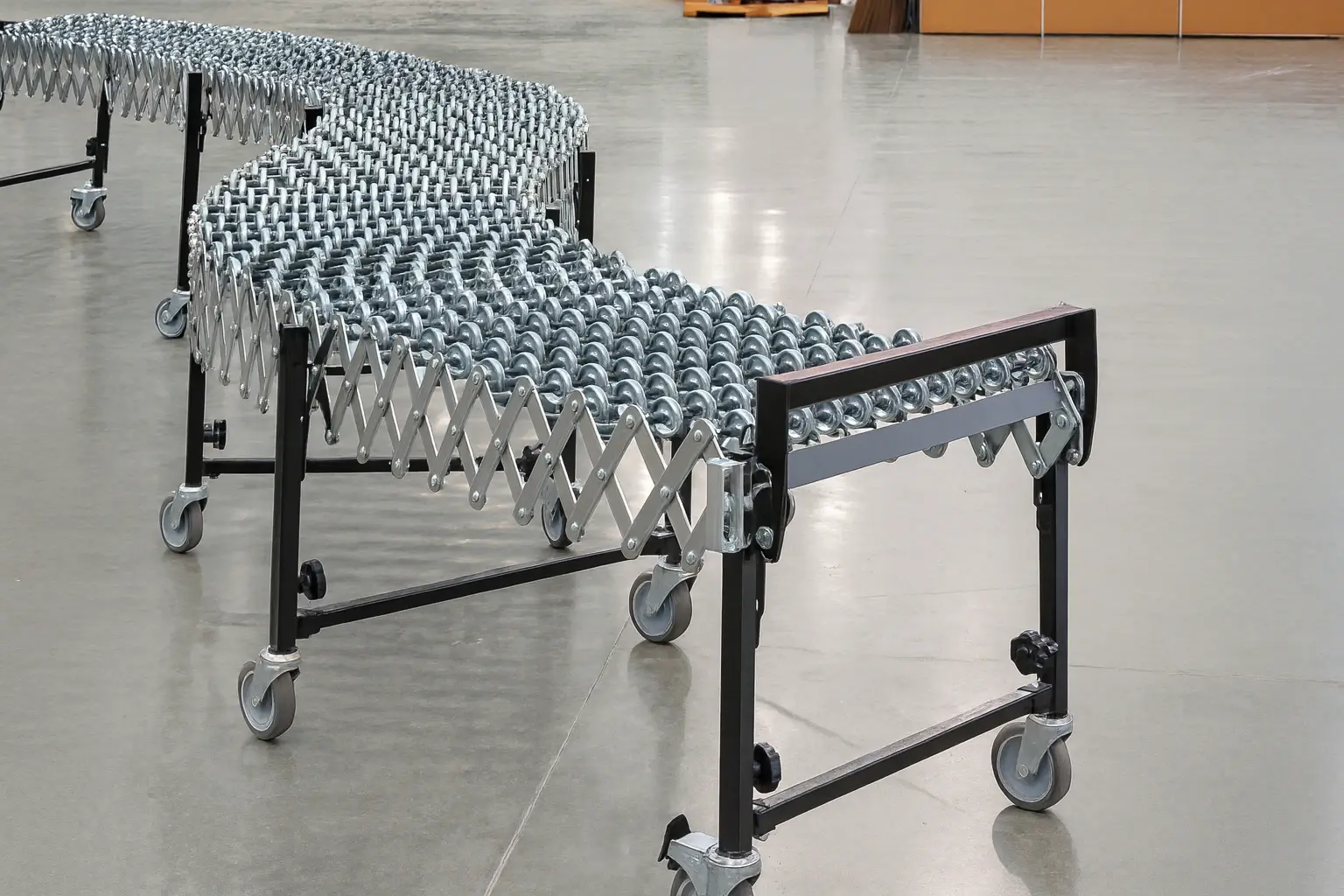 Portable expandable gravity conveyor with multiple metal rollers and gray TPR caster wheels