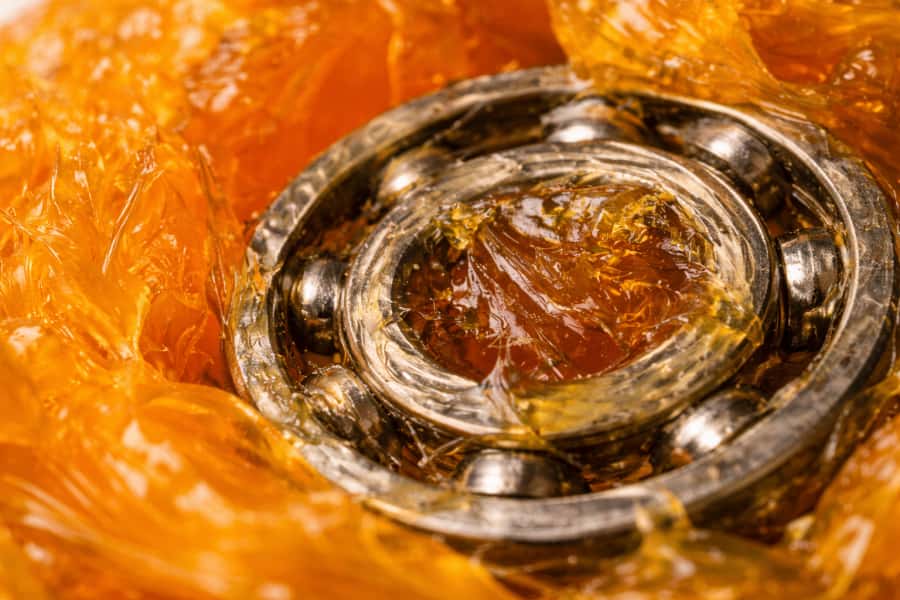 yellow lithium grease covering a ball bearing