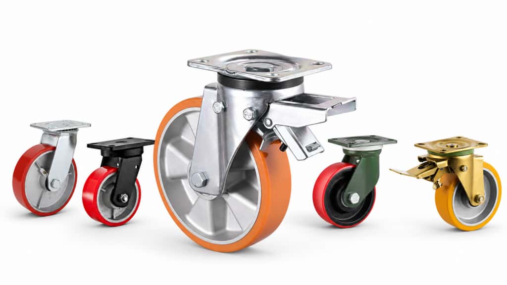 Five heavy-duty industrial caster wheels with red, orange, and yellow treads, arranged on a white background, showcasing different metal housings, sizes, and braking mechanisms.