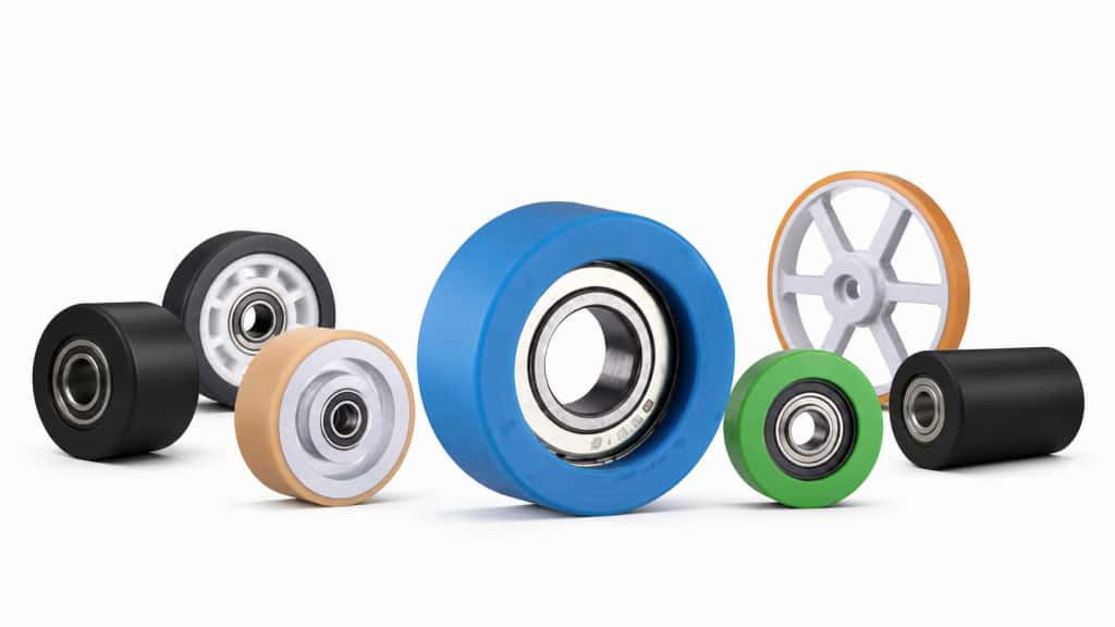 Assortment of logistic wheels and drive wheels with integrated bearings, featuring blue, green, black, and orange treads in various sizes and designs.